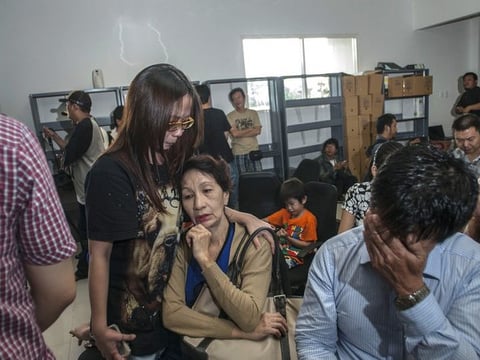 Family members of passengers of missing AirAsia flight QZ8501 gather at Juanda international airport in Surabaya, Indonesia, on Sunday, hours after the news the flight went missing. 